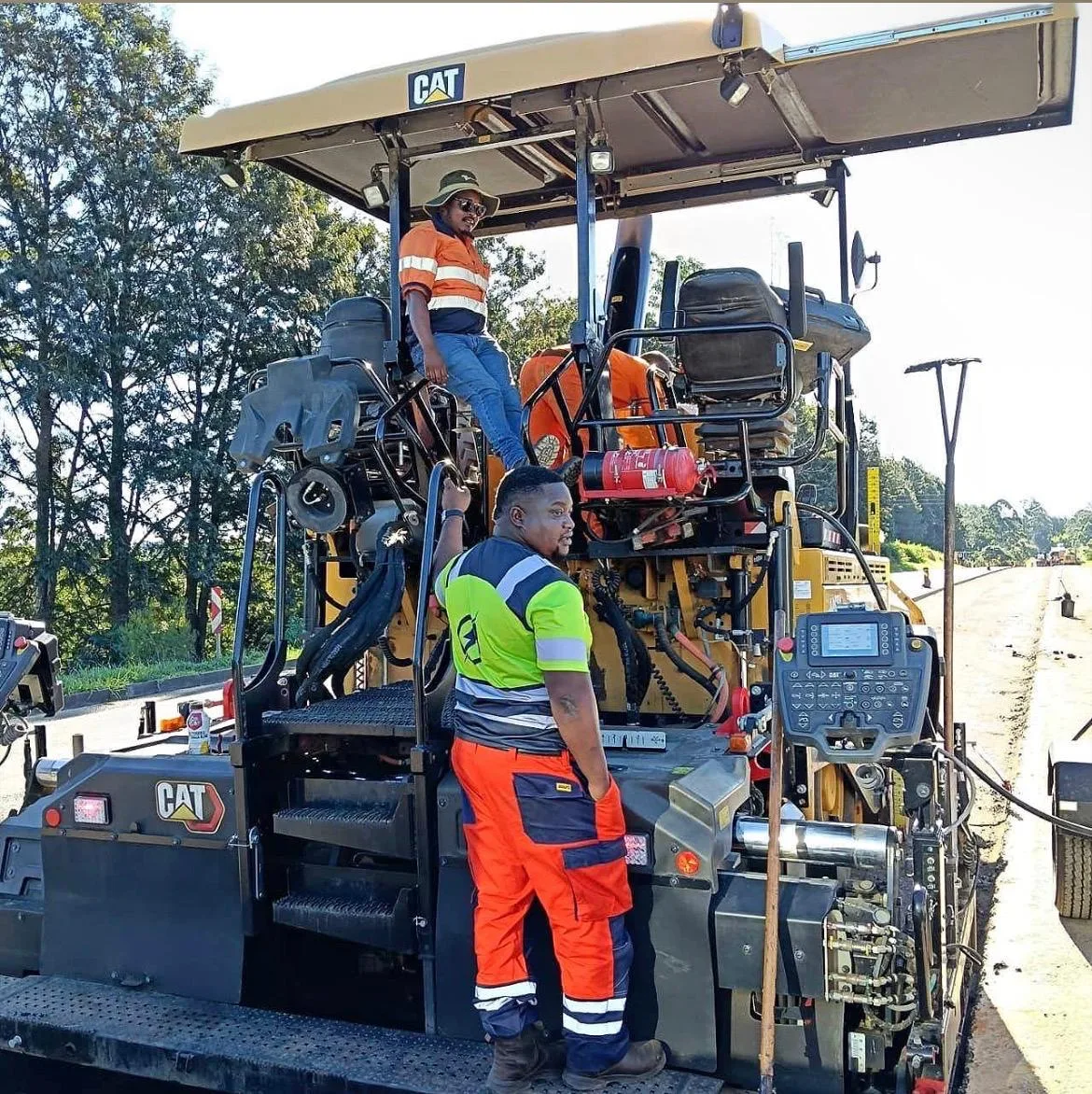 Izanolihle Roads crew laying a new surfacing layer from a CAT paver.
